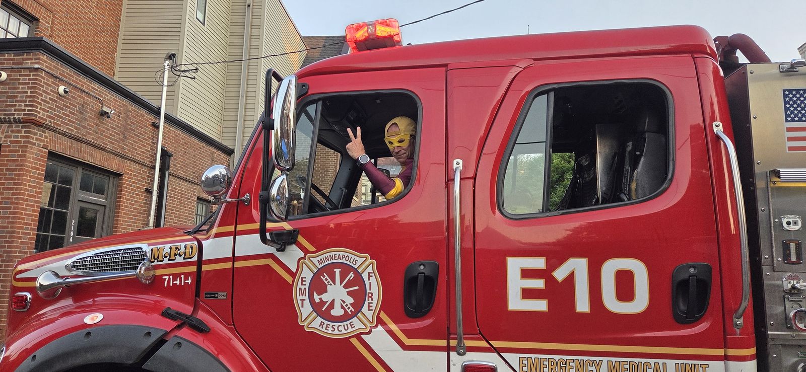 AOK Man waving from the cab of Minneapolis Fire Engine 10